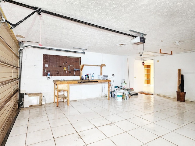 garage with a workshop area and a garage door opener