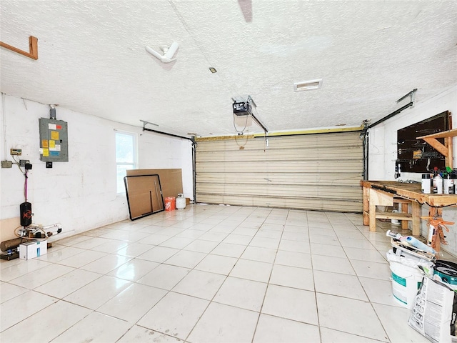 garage with a garage door opener and electric panel