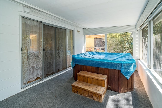 sunroom featuring a jacuzzi