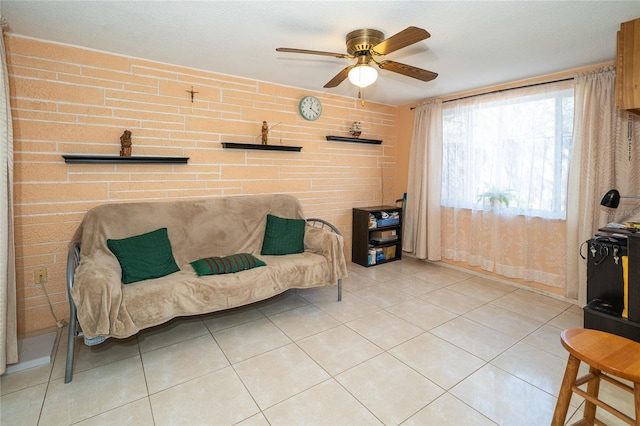 living area with tile patterned flooring and ceiling fan