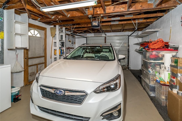 garage featuring a garage door opener and washer / clothes dryer