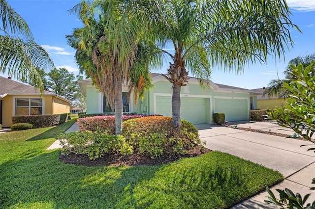 ranch-style home featuring a garage, driveway, a front lawn, and stucco siding