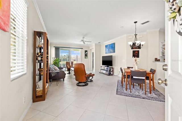 interior space with light tile patterned floors, visible vents, crown molding, and ceiling fan with notable chandelier