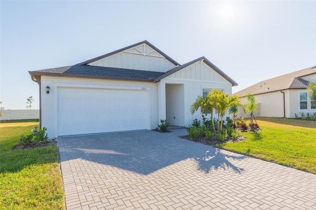 view of front of house with a garage and a front yard