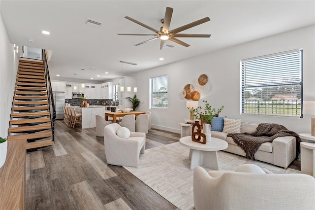 6207 64th Way N, Pinellas Park, FL 33781 - living room featuring ceiling fan, wood finished floors, stairs, recessed lighting, and baseboards