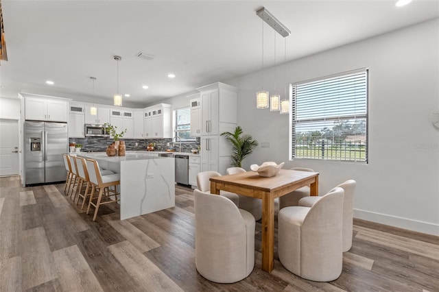 6207 64th Way N, Pinellas Park, FL 33781 - dining area with wood finished floors, recessed lighting, and baseboards