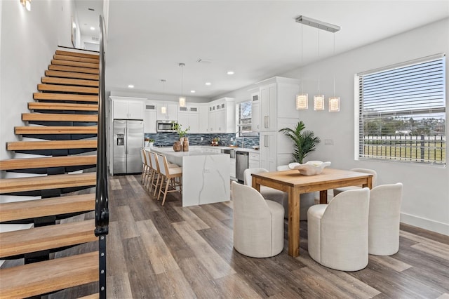 6207 64th Way N, Pinellas Park, FL 33781 - dining space featuring plenty of natural light, dark wood-type flooring, stairs, recessed lighting, and baseboards