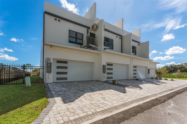 6207 64th Way N, Pinellas Park, FL 33781 - view of front of home featuring a garage, stucco siding, and decorative driveway