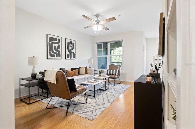 living room featuring ceiling fan and wood-type flooring