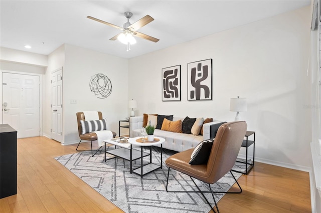 living room with hardwood / wood-style flooring and ceiling fan