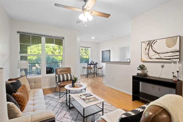 living room featuring ceiling fan and light wood-type flooring