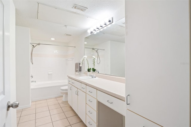 full bathroom with tiled shower / bath, tile patterned flooring, vanity, toilet, and a textured ceiling