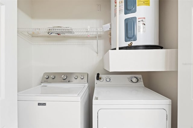 washroom featuring washing machine and dryer and electric water heater