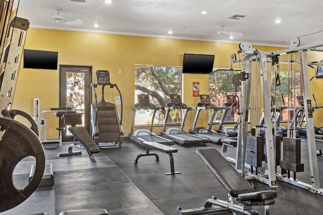 exercise room with crown molding and a textured ceiling