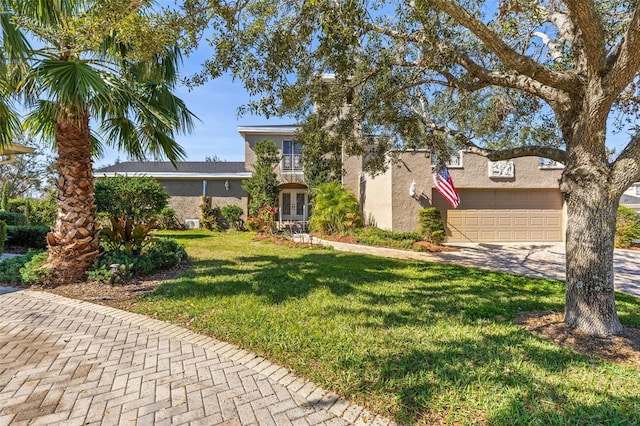 view of front facade with a garage, a front lawn, and french doors