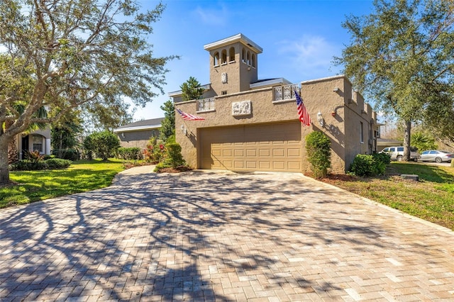 view of front of property with a garage and a front lawn