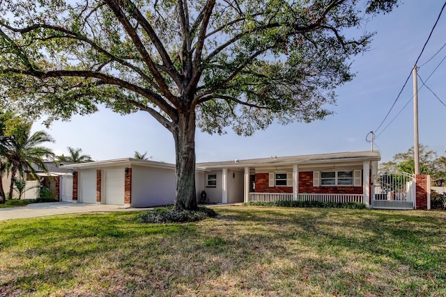 ranch-style house with a front yard, brick siding, driveway, and an attached garage