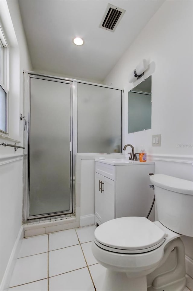 bathroom with visible vents, a shower stall, toilet, and tile patterned floors