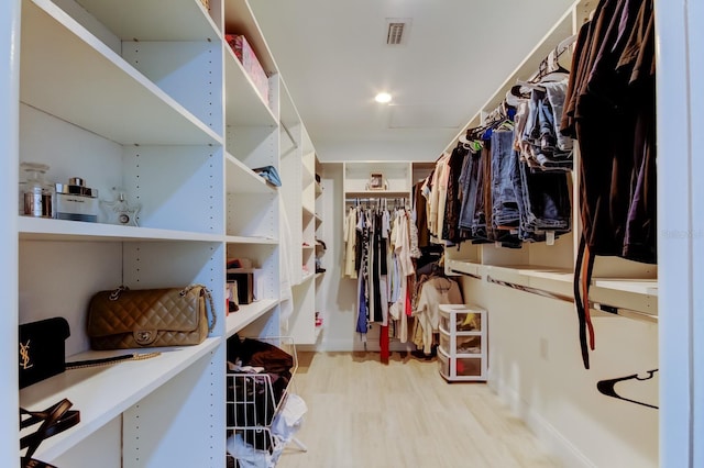 walk in closet with visible vents and wood finished floors