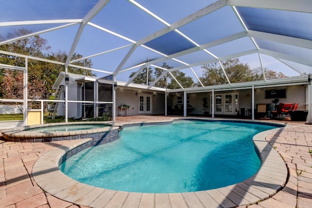 view of pool featuring a patio, french doors, a lanai, and a pool with connected hot tub