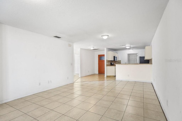 unfurnished living room with light tile patterned flooring