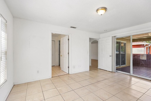 spare room with a healthy amount of sunlight and light tile patterned floors