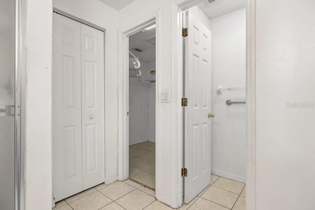 hall with light tile patterned floors