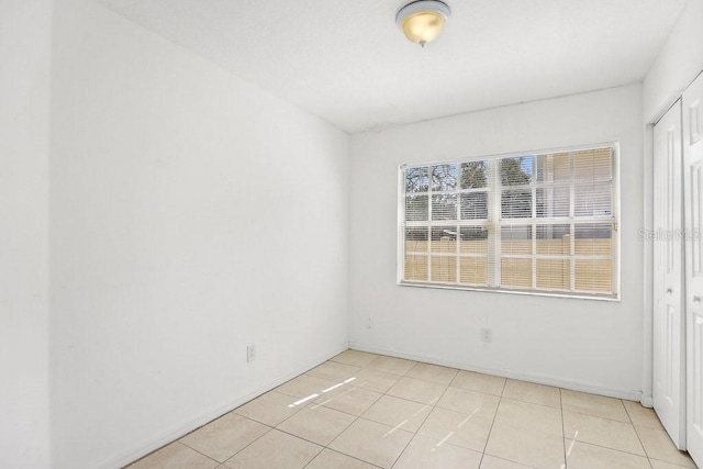 spare room with light tile patterned floors