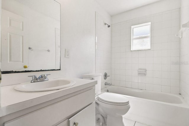 full bathroom with tiled shower / bath combo, vanity, and toilet