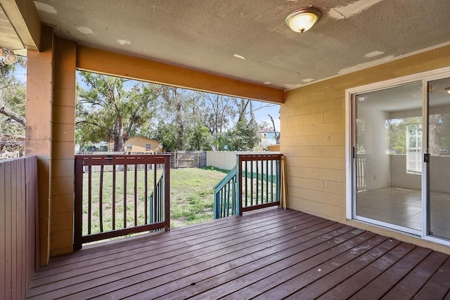 wooden terrace featuring a yard