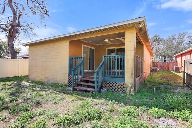 back of house featuring cooling unit