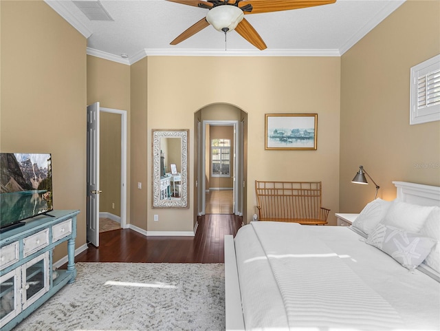 bedroom featuring ornamental molding, dark hardwood / wood-style floors, and ceiling fan