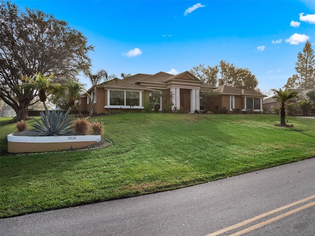 single story home featuring a front yard