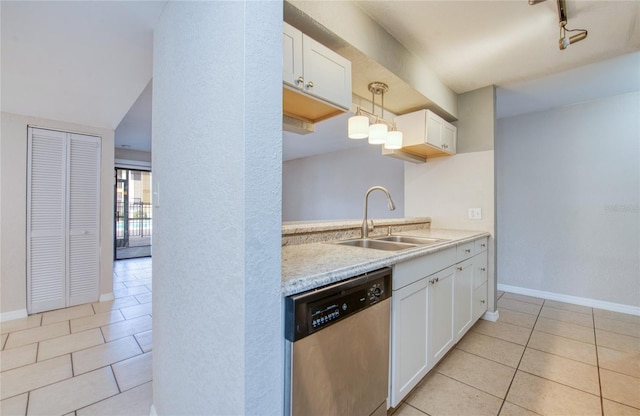 kitchen featuring sink, white cabinetry, light tile patterned floors, dishwasher, and pendant lighting