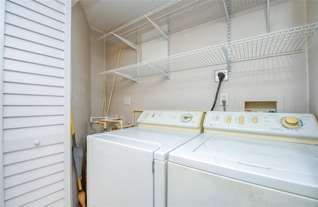 clothes washing area with washing machine and dryer