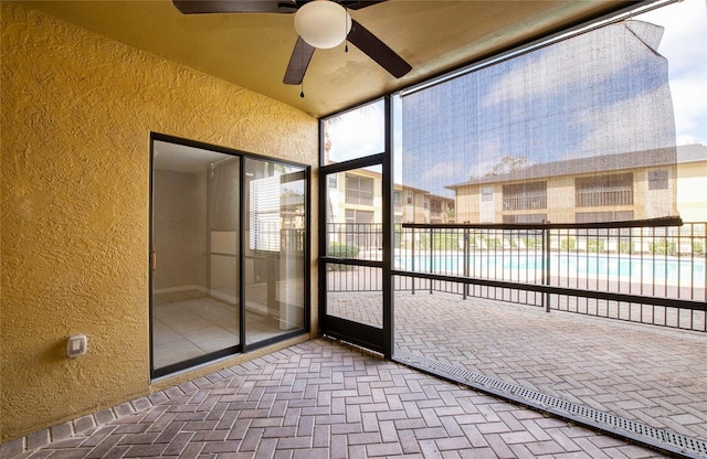 unfurnished sunroom featuring vaulted ceiling and ceiling fan