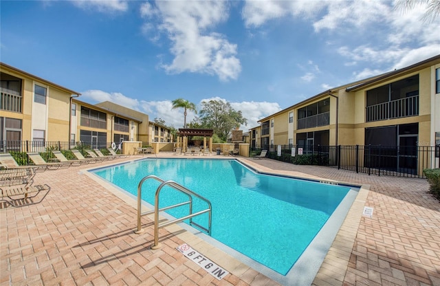 view of swimming pool featuring a patio area and a pergola