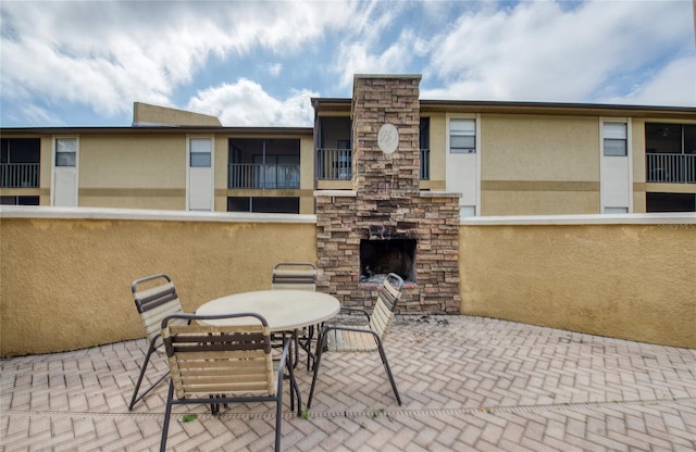 view of patio / terrace featuring an outdoor stone fireplace