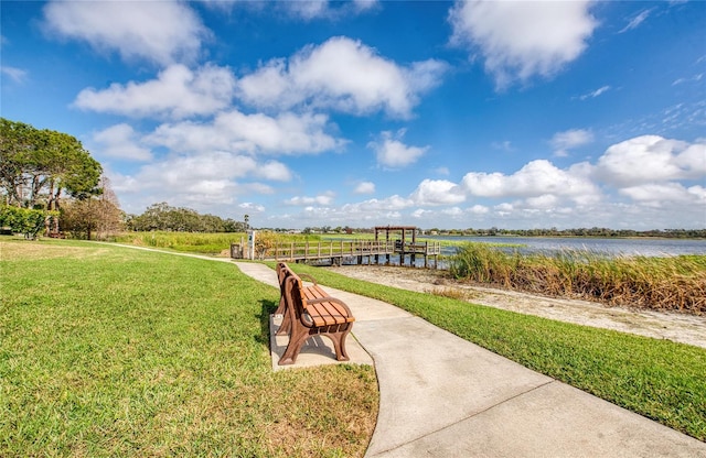 view of community with a water view and a lawn