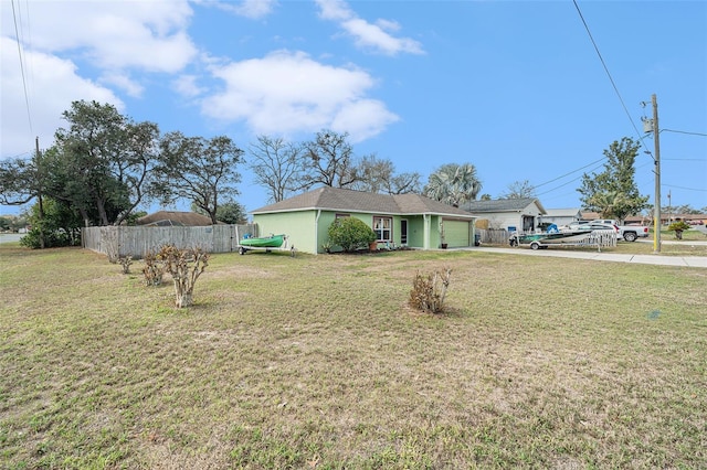 view of front of house featuring a garage and a front yard