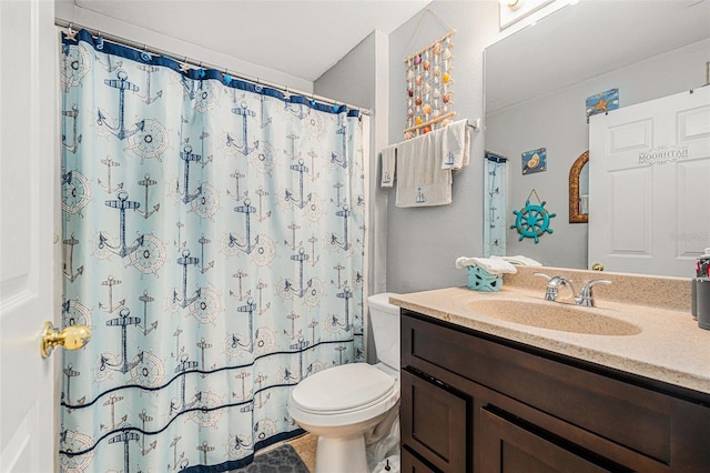 bathroom featuring vanity, a shower with shower curtain, and toilet