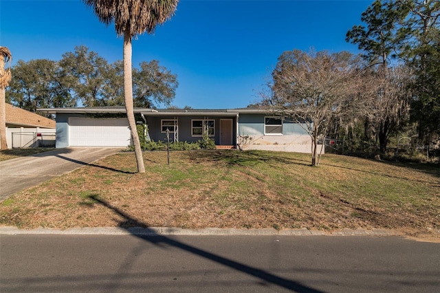 ranch-style home with a garage and a front yard