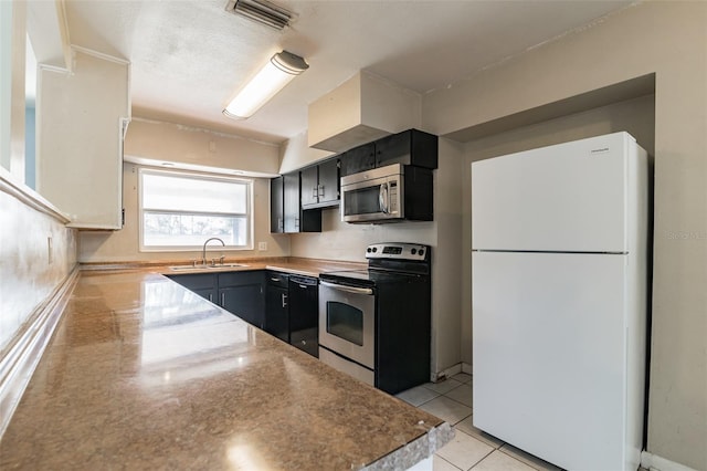 kitchen featuring sink, stainless steel appliances, and light tile patterned flooring