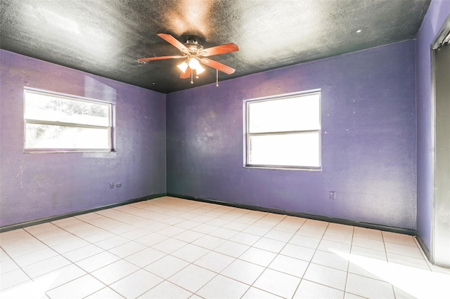 unfurnished room featuring ceiling fan, a textured ceiling, and light tile patterned floors