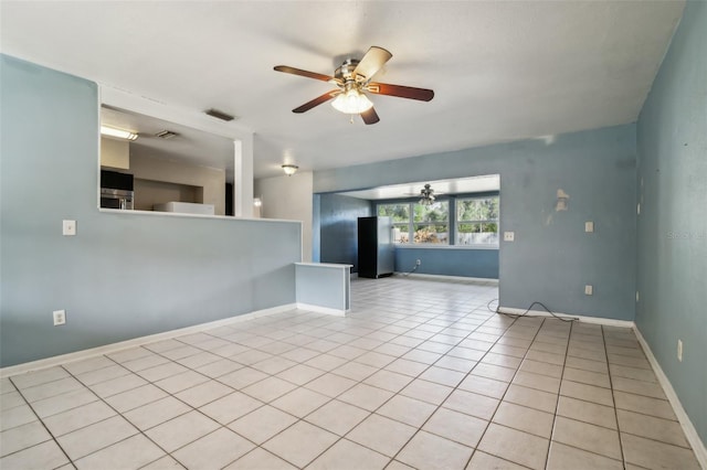 tiled spare room with ceiling fan