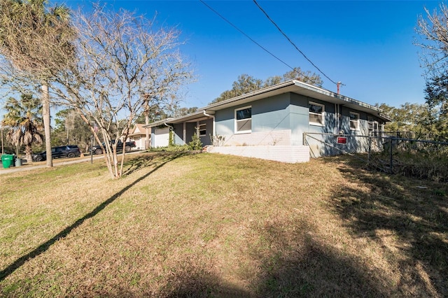 back of house featuring a yard