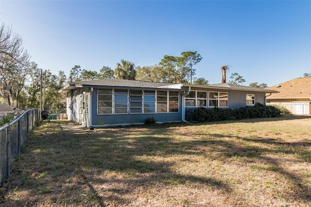 rear view of house with a lawn