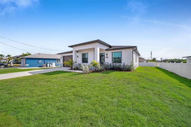 view of front facade with a garage and a front yard