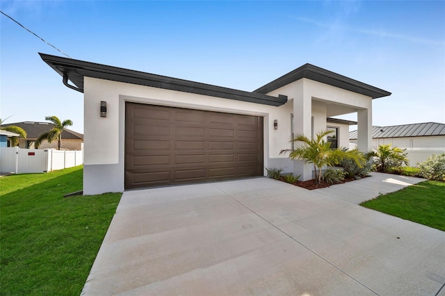 modern home featuring a garage and a front lawn