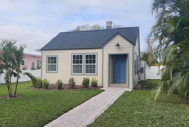 bungalow-style home with a front lawn